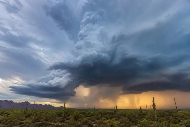 Towering monsoon storm cell with a golden dust skirt over the West Valley